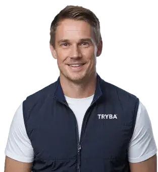 Un homme souriant, portant un gilet bleu avec le logo 'TRYBA', se tient face à la caméra.