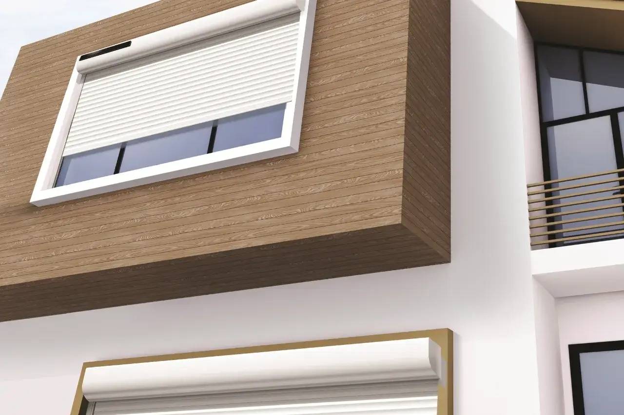 Une fenêtre moderne avec un volet roulant blanc encadrée de bois sur une façade blanche.