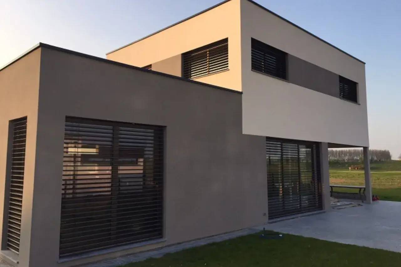 Maison moderne aux lignes épurées avec de grandes fenêtres et un extérieur en deux tons.